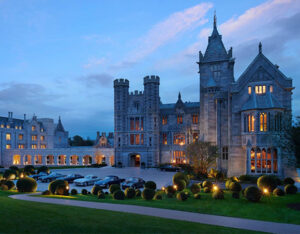Golf Tours a large castle with many cars parked in front of it